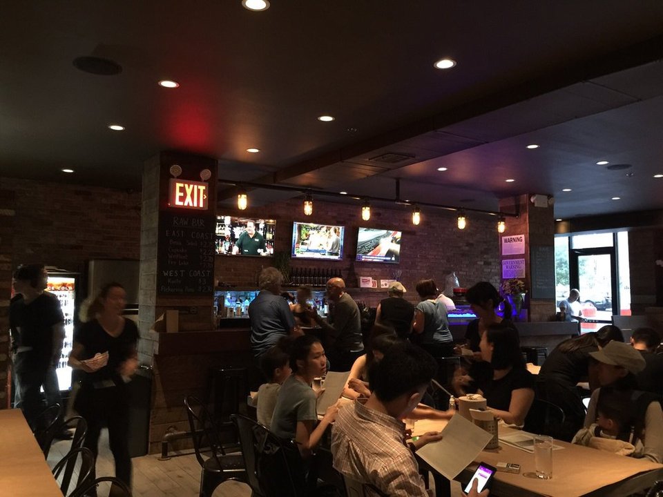 Brick-lined dining room with casual seafood tables.
